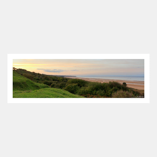 Photographie panoramique d'un coucher de soleil sur la plage à marée basse à Omaha Beach depuis les collines du WN62 de Colleville-sur-Mer, Débarquement du 6 juin 1944, Calvados, Normandie, France.